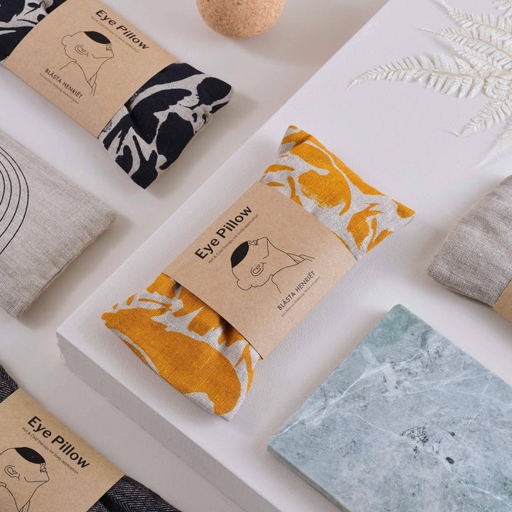 Eye pillows with packaging on a white surface