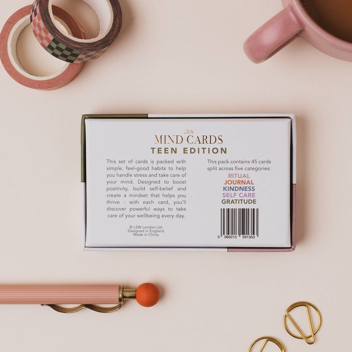 Box of 'MIND CARDS TEEN EDITION' on a light surface with stationery items.