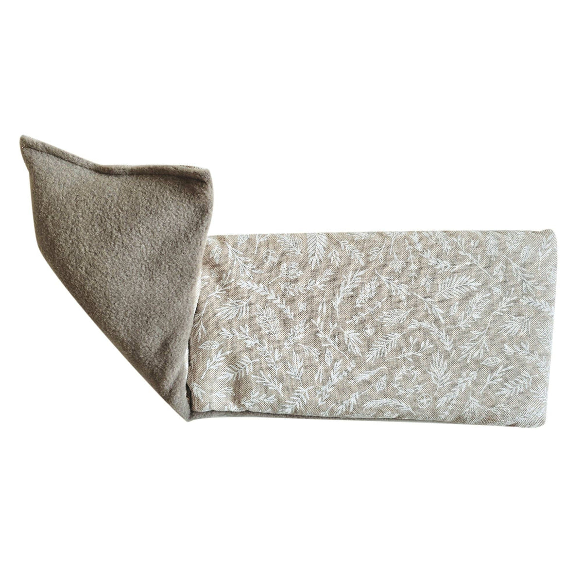 Fabric wheat bag with leaf pattern and textured edge on a white background