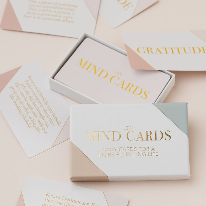 Set of 'MIND CARDS' with 'Gratitude' and 'Daily Cards for a More Fulfilling Life' on a light pink background.
