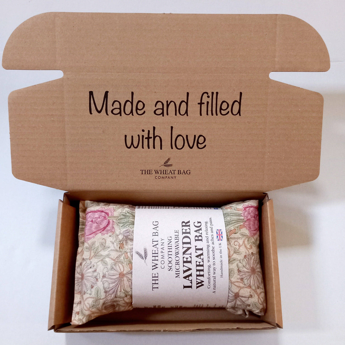 Wheat bag in a cardboard box with 'Made and filled with love' text and The Wheat Bag Company branding.