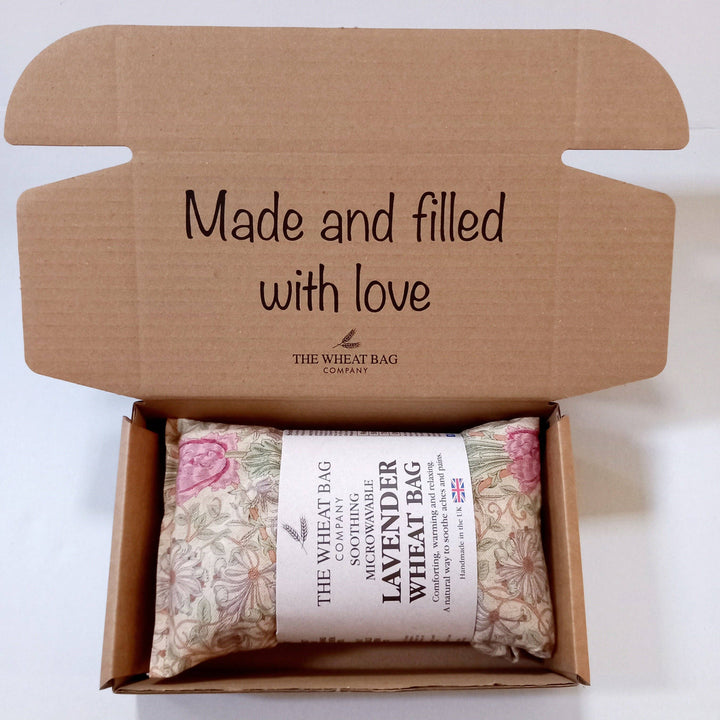 Wheat bag in a cardboard box with 'Made and filled with love' text and The Wheat Bag Company branding.
