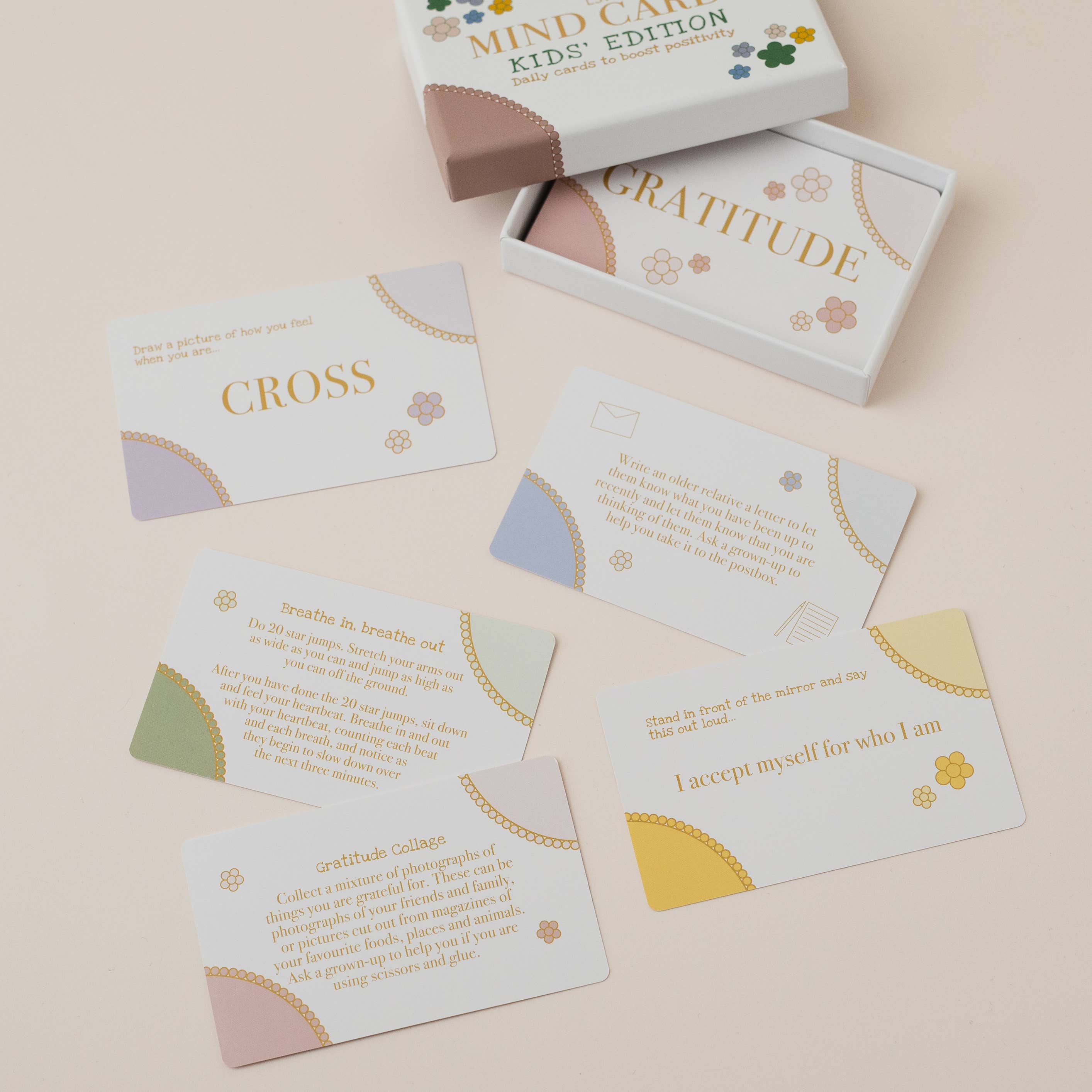 Mind Care Kids Edition card set with 'Gratitude' and 'Cross' cards on a beige background