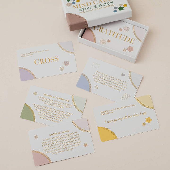Mind Care Kids Edition card set with 'Gratitude' and 'Cross' cards on a beige background
