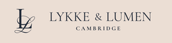 Lykke & Lumen Cambridge logo on a light beige background, featuring a stylized dark navy monogram and serif text.