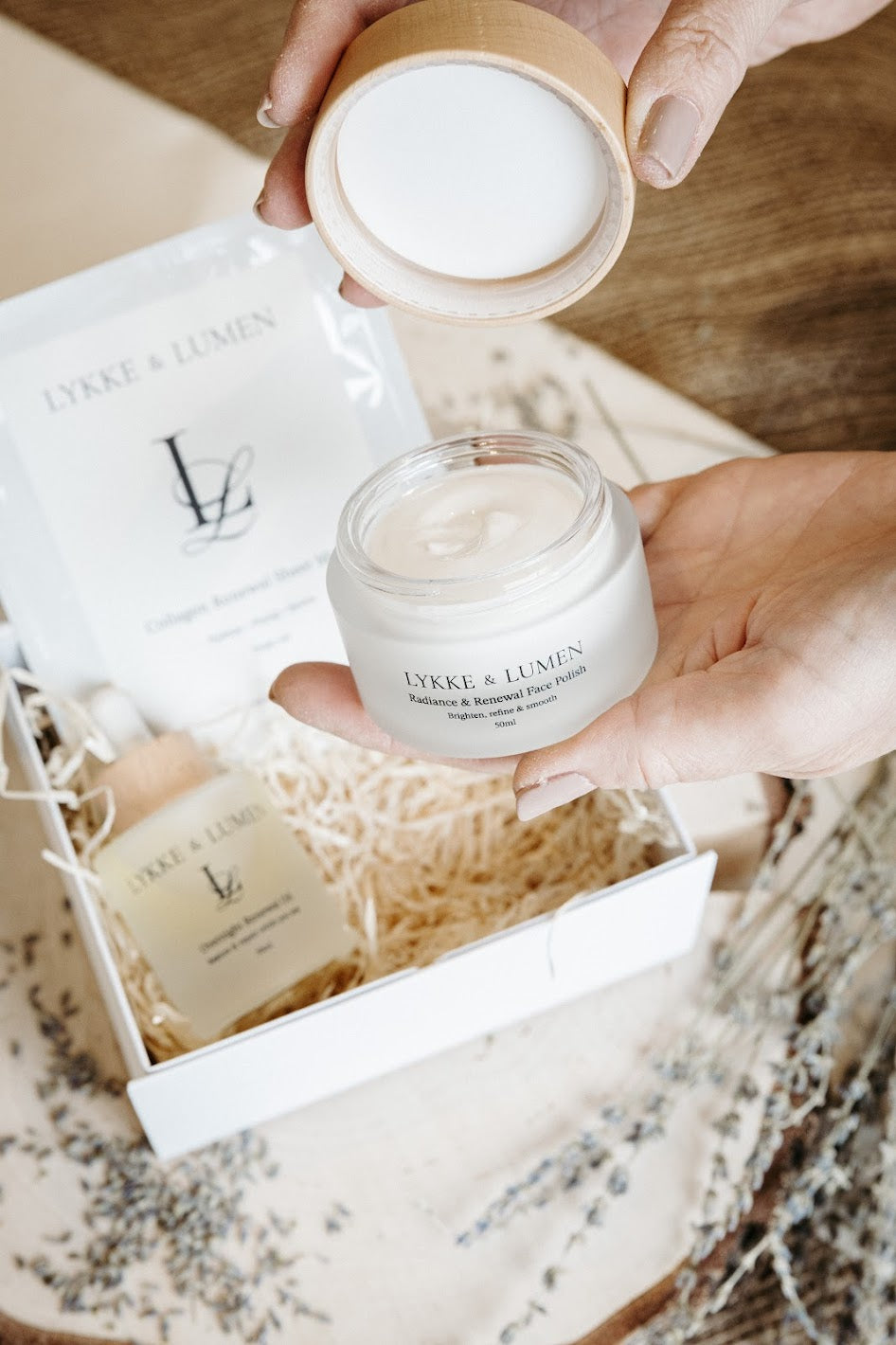 Luxury Lykke & Lumen skincare gift box featuring Radiance & Renew Face Polish, Overnight Renewal Oil and Collagen Renewal Sheet Mask in a white magnetic presentation box with soft natural styling.