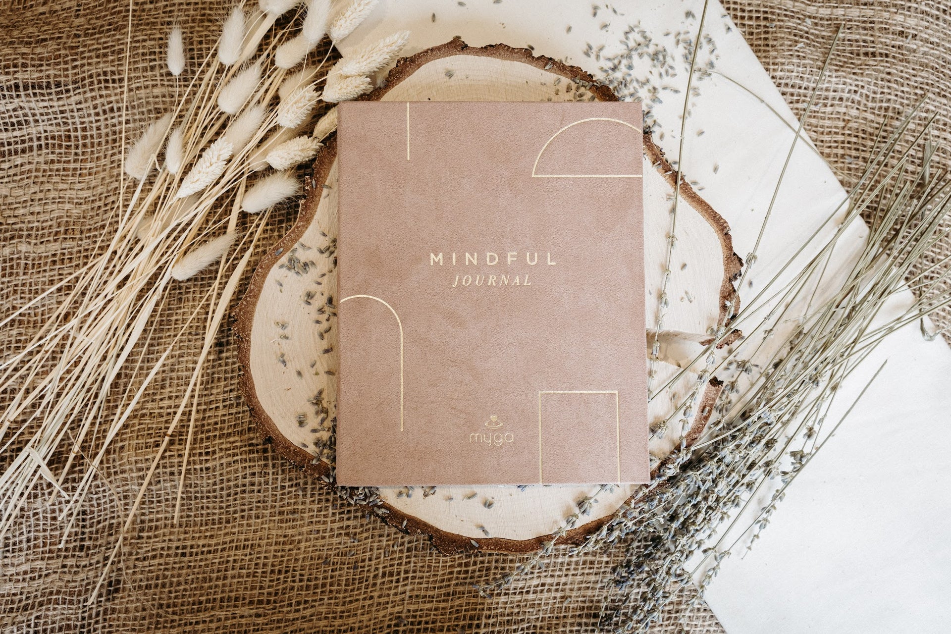 Lykke & Lumen mindful journal styled with dried lavender in a calming wellness setting.