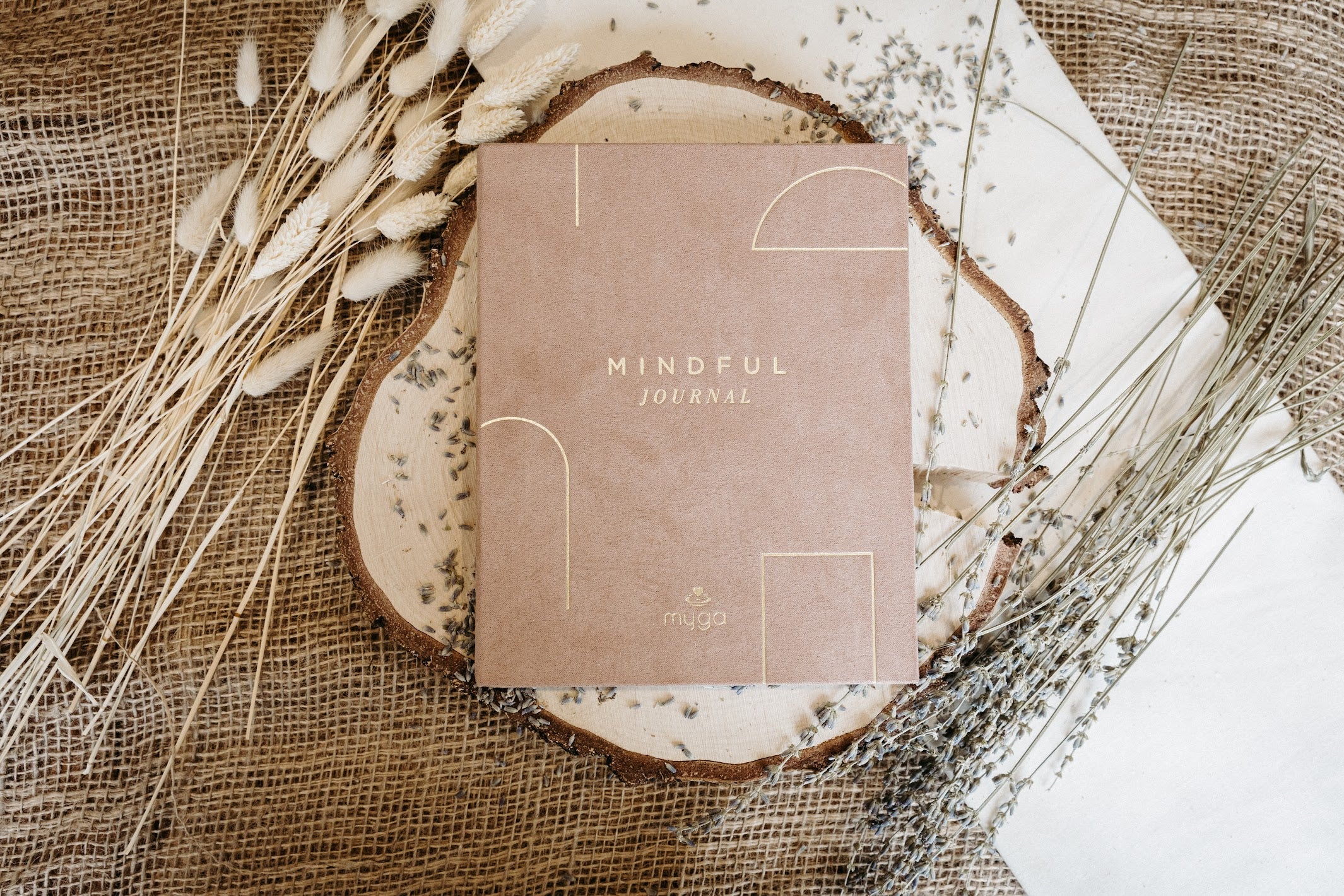 Lykke & Lumen mindful journal styled with dried lavender in a calming wellness setting.