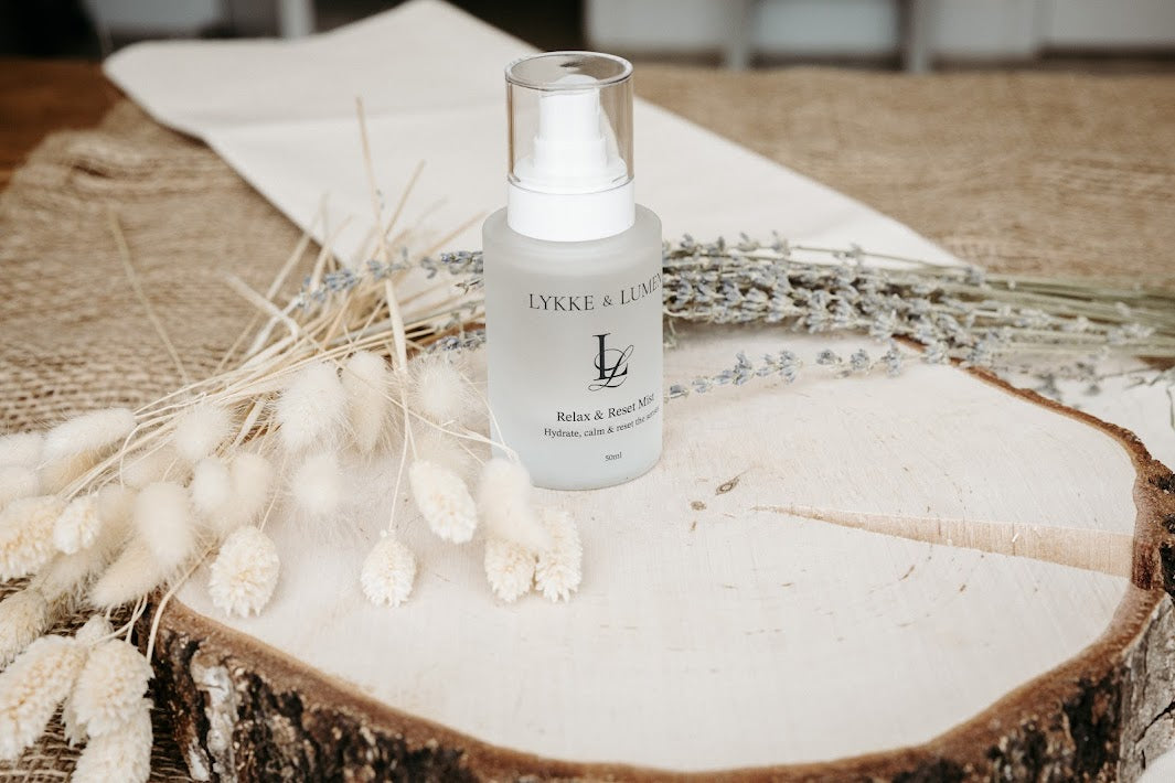 Lykke & Lumen Relax & Reset Mist hydrating face and pillow mist styled with dried lavender in a calming wellness setting