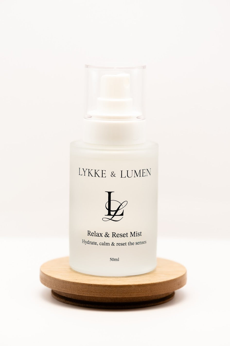 Lykke & Lumen Relax & Reset Mist hydrating face and pillow mist in frosted glass bottle on white background.