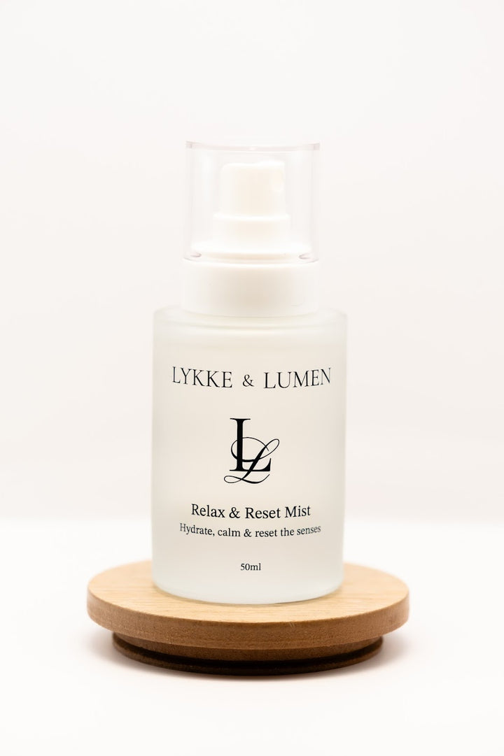 Lykke & Lumen Relax & Reset Mist hydrating face and pillow mist in frosted glass bottle on white background.