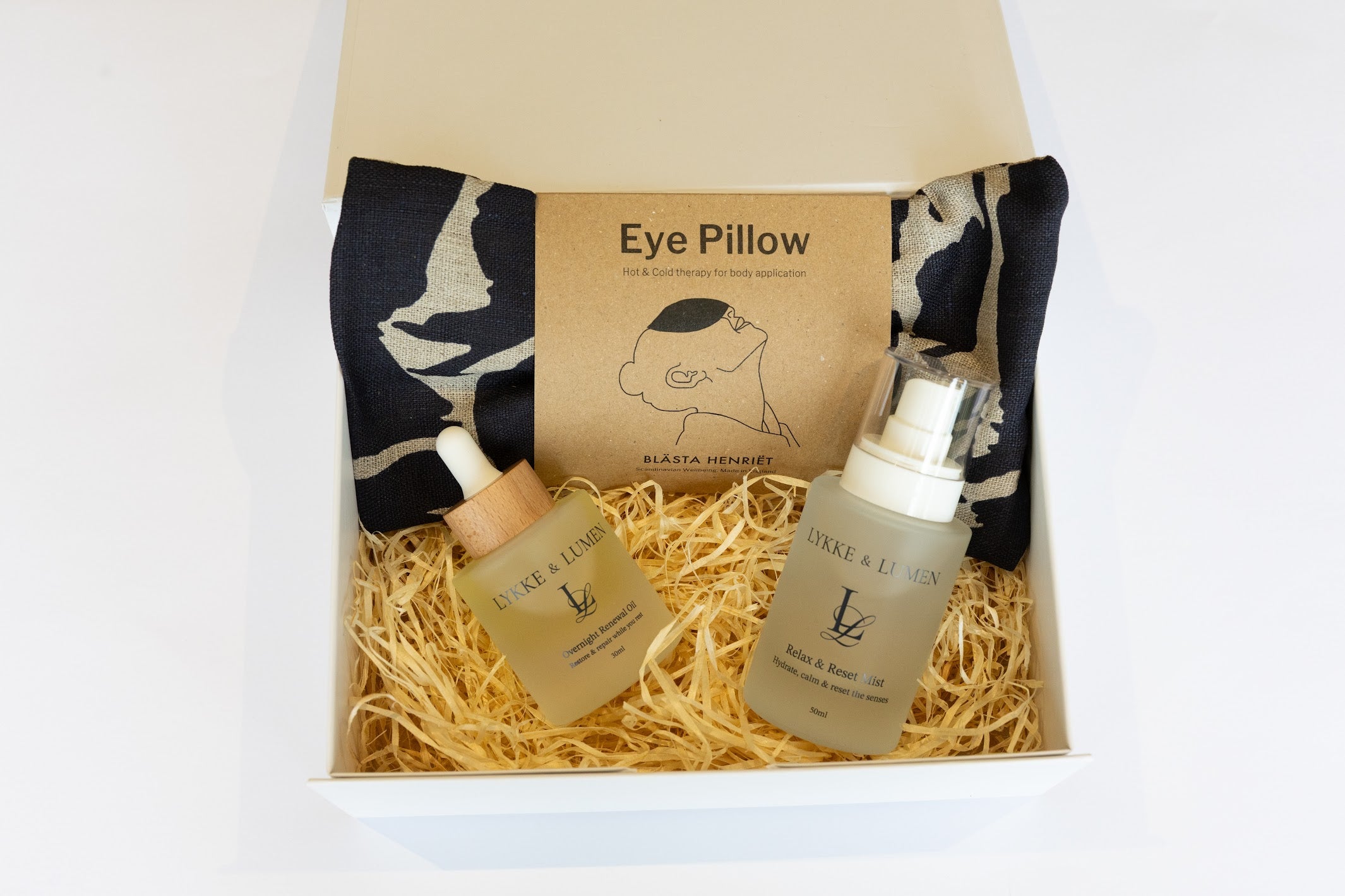 Lykke & Lumen self-care gift set featuring Overnight Renewal Oil, Relax & Reset Mist and a soothing eye pillow in a luxury wellness gift box designed for rest and relaxation.