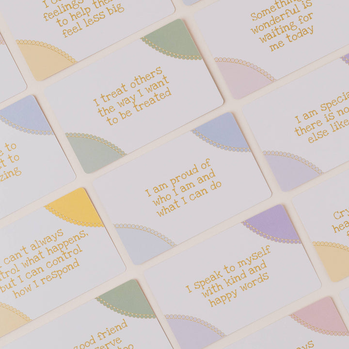 Motivational phrases on small square tiles with pastel backgrounds
