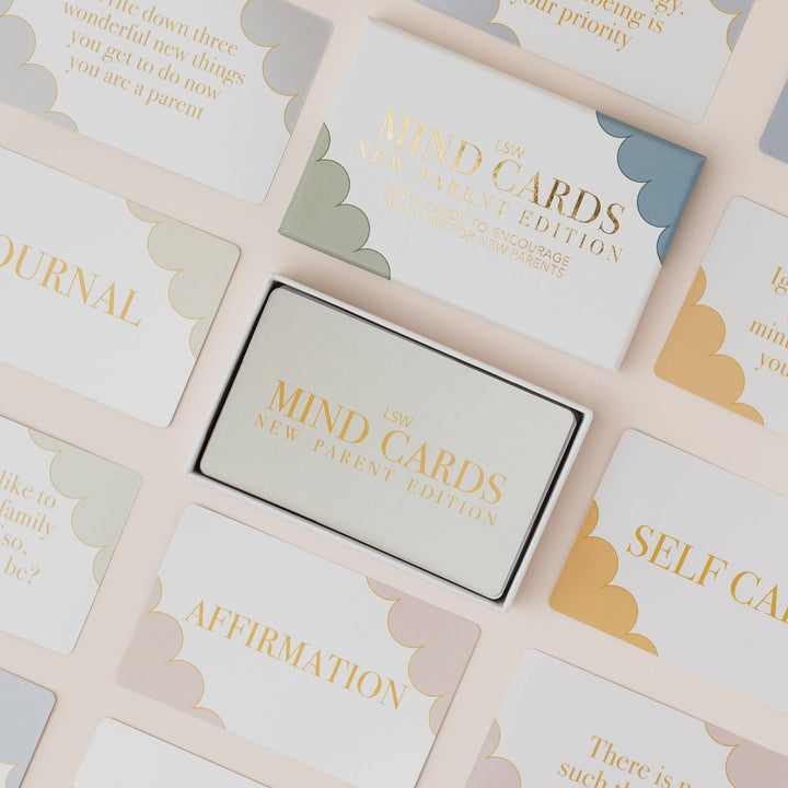 Mind Cards packaging surrounded by cards with text on a light background