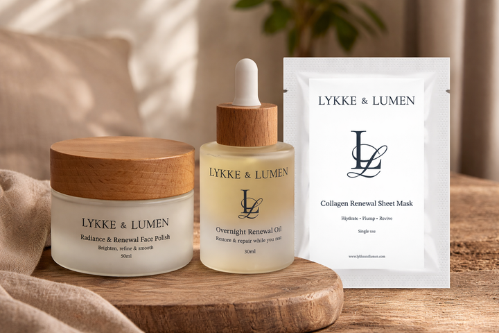 LYKKE & LUMEN skincare products including a jar of Radiance & Renewal Face Polish, bottle of overnight renewal oil and Collagen sheet mask on a wooden surface.